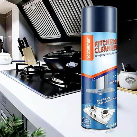 Xtcare Kitchen Cleaner spray can on a modern kitchen counter with a cooking stove and utensils in the background.