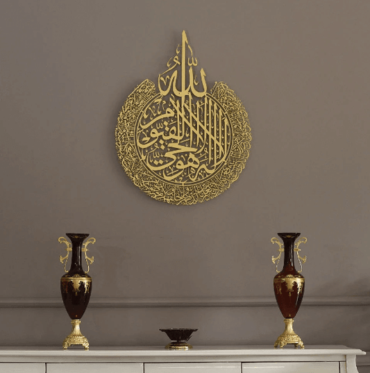 Elegant gold wall art featuring Arabic calligraphy, complemented by decorative vases on a stylish modern display.